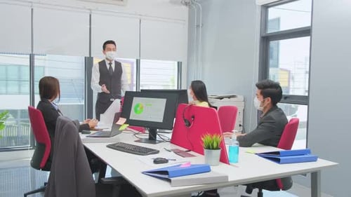 Group of Asian team business people working and meeting in office with new normal social distancing