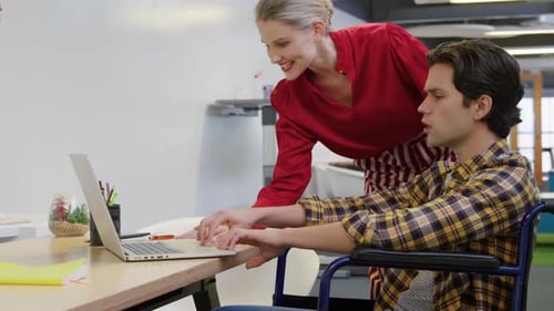 Young man and woman working in a creative office