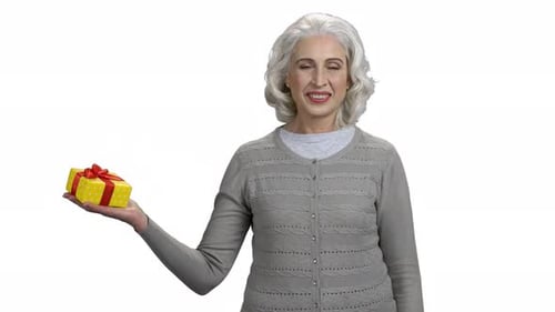 Smiling Senior Woman Holding a Birthday Gift