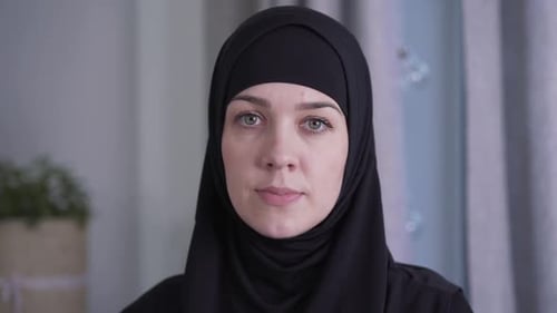 Close-up Portrait of Young Beautiful Muslim Woman in Traditional Black Hijab