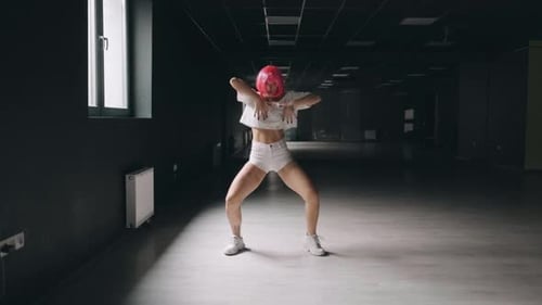 Hot Girl Is Dancing at the Dark Studio Background. Sexy Pink Woman Is Practicing Dance