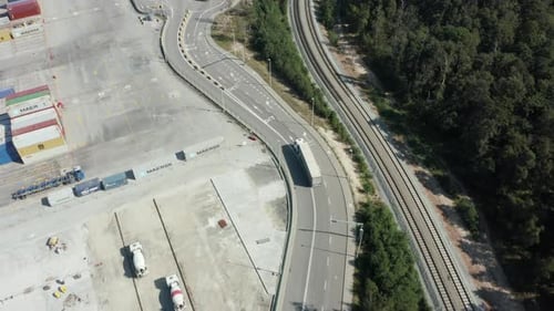 Aerial View of a Truck Entering the Port to Load Cargo From a Container Ship