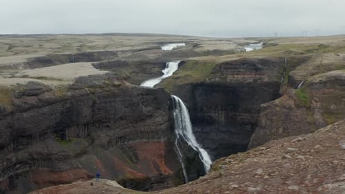 Amazing Panoramic Aerial Shot of Water Falling Into Deep Canyon