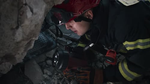 Firefighter Searches Through Rubble After Urban Disaster
