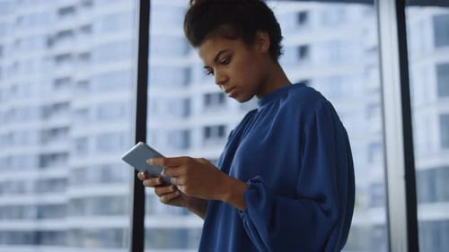 Woman Using Tablet in Urban Office Setting