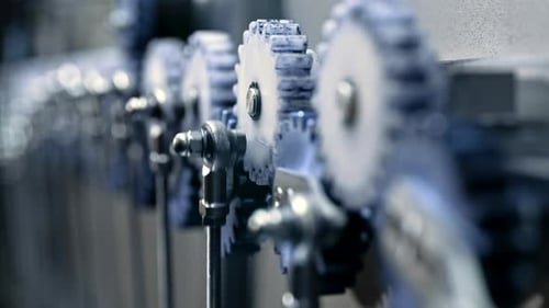 Closeup of Steel Gears Spinning Inside Complex Engine Mechanism