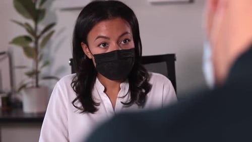 Businesswoman Talking to Man and Sitting at Table in Company During Pandemic Spbi