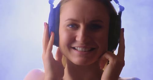 Woman Smiling Wearing Headphones Listening to Music