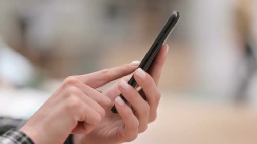 Female Hands Using Smartphone Close Up