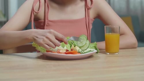 Woman Enjoys Healthy Salad and Orange Juice