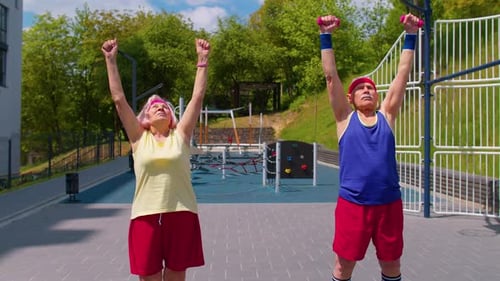 Active Seniors Doing Dumbbell Exercises in Park
