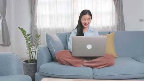 Adult Woman on Couch With Laptop Indoors