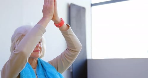 Silver Haired Woman Doing Yoga Meditation