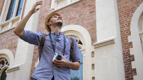 Stylish Tourist Exploring Old City Architecture During Daytime