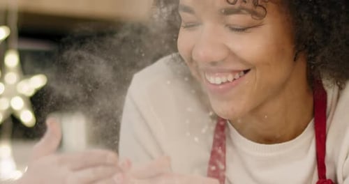 Tilt up view of mum and daughter playing with flour