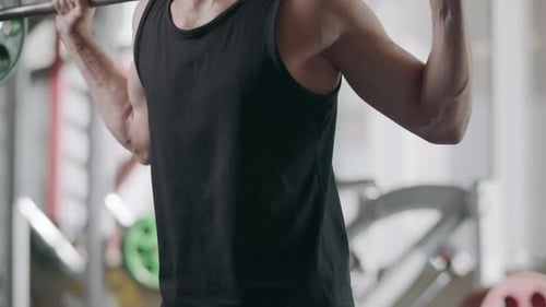 Sportsman Training Squat Exercise with Barbell in Fitness Club
