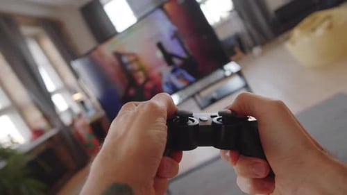 Hands Playing Video Game on Controller at Home