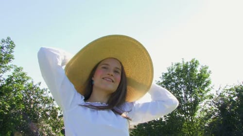 Woman Wearing Sun Hat Outdoors in Summer Sunlight