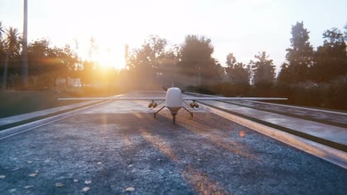 Military Drone with Missiles on Runway at Golden Hour