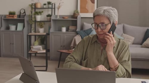 Senior Woman Working at Home with Technology