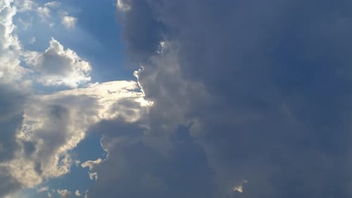 Sun Shining Through the Clouds in Blue Sky