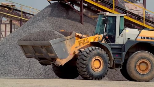 Excavator at mining quarry. View of bulldozer moving at quarry