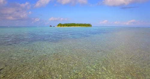 Aerial drone view of a scenic tropical island in the Maldives.