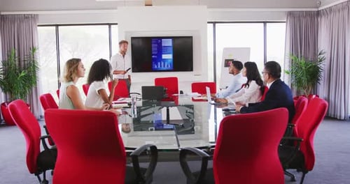 Professional businessman giving presentation in meeting room in modern office in slow motion