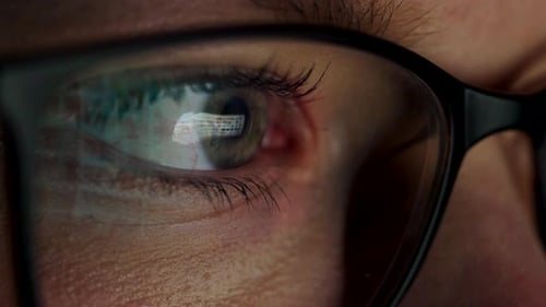 Femme à lunettes regardant le moniteur et surfant sur Internet