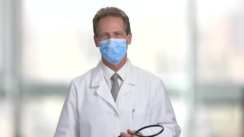 Doctor with Mask Put on Stethoscope on His Neck.