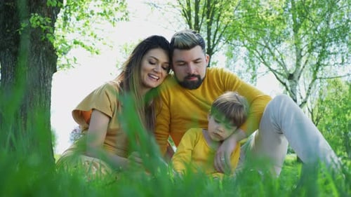 Family Togetherness in Green Park Reading a Book