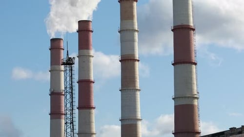 Smoke From Factory Pipes Against The Blue Sky