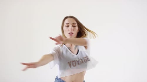 Young Beautiful Female Dancer Smiling and Dancing in Studio