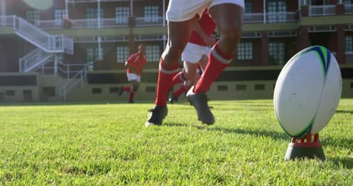 Rugby player kicking the ball from the kicking tee in the stadium 4k