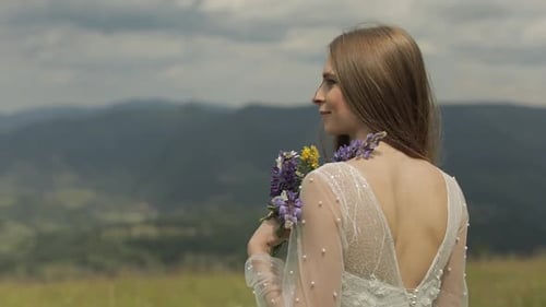 Woman with Bouquet in Mountains