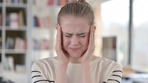 Young Woman Massaging Temples During Headache