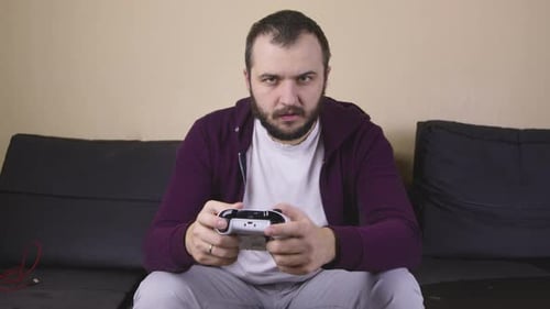 Man Playing Video Games with Controller Indoors