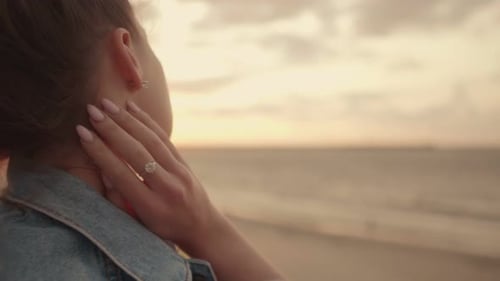 Woman Enjoys Beautiful Sunset on Sandy Beach