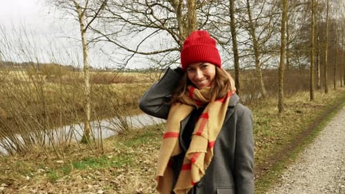 Woman Walks Along Rural Path in Winter Clothes