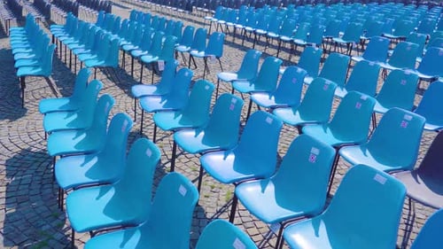Blue Plastic Chairs Lined Up in Row for Events Observation