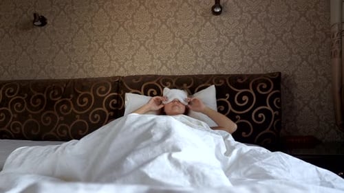Woman Wakes Up and Stretches in Bed