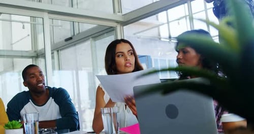 Diverse Team Discussing Business in Modern Office