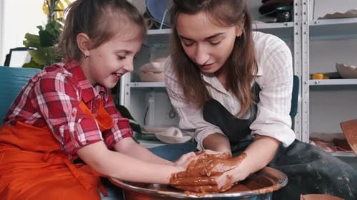 Girl and Woman Making Pottery Together