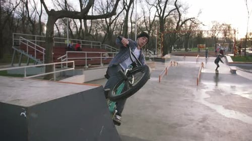 BMX Rider Doing Tricks in Street Plaza Bicycle Stunt Rider in Cocncrete Skatepark Super Slow Motion