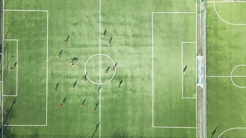 Aerial View of Soccer Players Playing Football on Green Sports Stadium