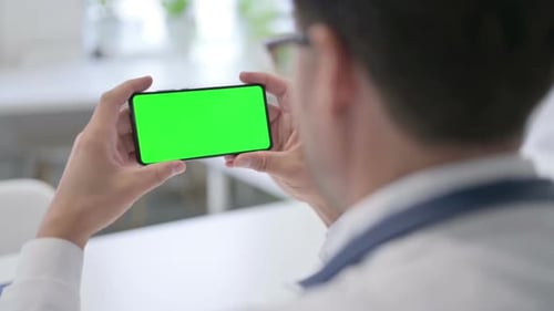 Doctor Holding Smartphone with Green Chroma Key Screen