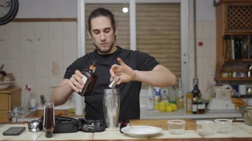 Young Adult Making a Cocktail at Home