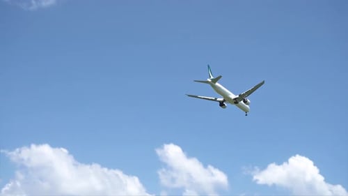 Airplane Flying in Blue Sky Before Landing