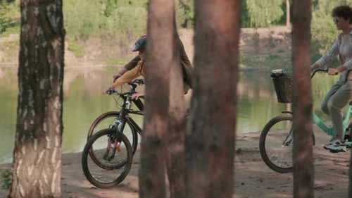 Family Riding Bikes Together In Park