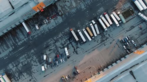 Motion Above Truck Asphalt Parking Area Between Buildings